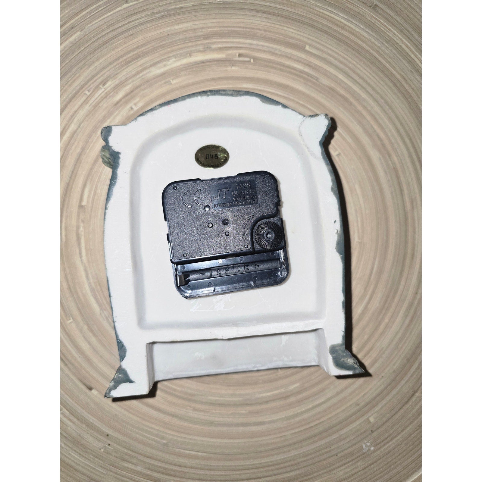 This decorative, hand-painted ceramic or resin tabletop clock